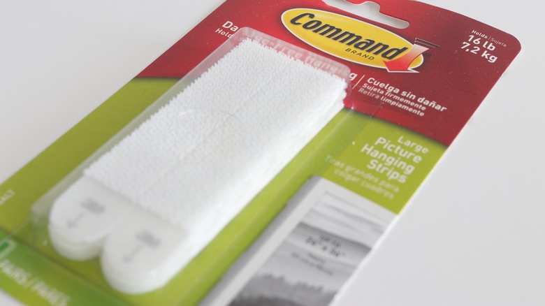 Unopened pack of 3M picture hanging strips against white background.