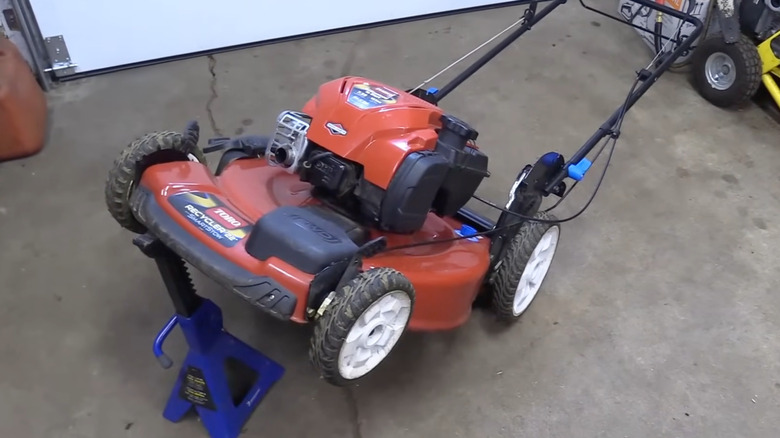 A lawn mower tipped on its back.