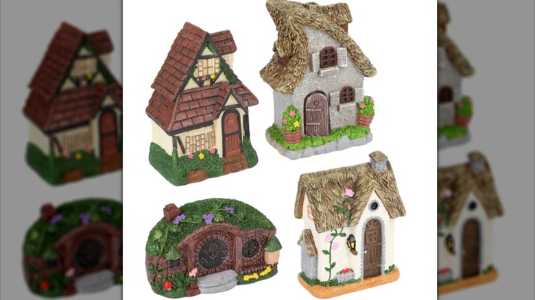 Tiny houses made of resin and sculpted to look like cottages for gnomes