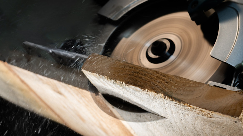 Person cutting wood with a circular saw