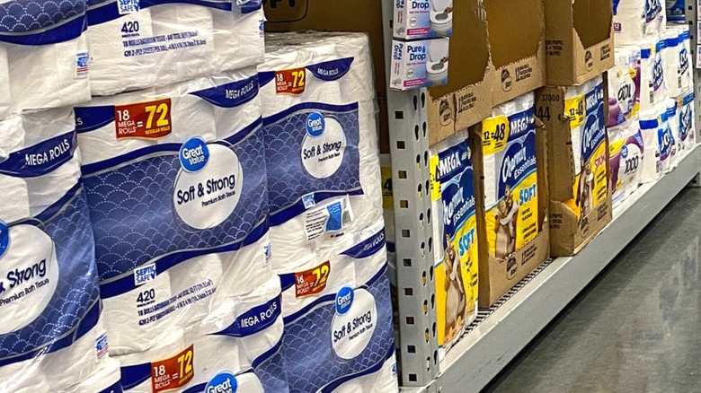 Packs of Great Value and Charmin toilet paper on Walmart shelves