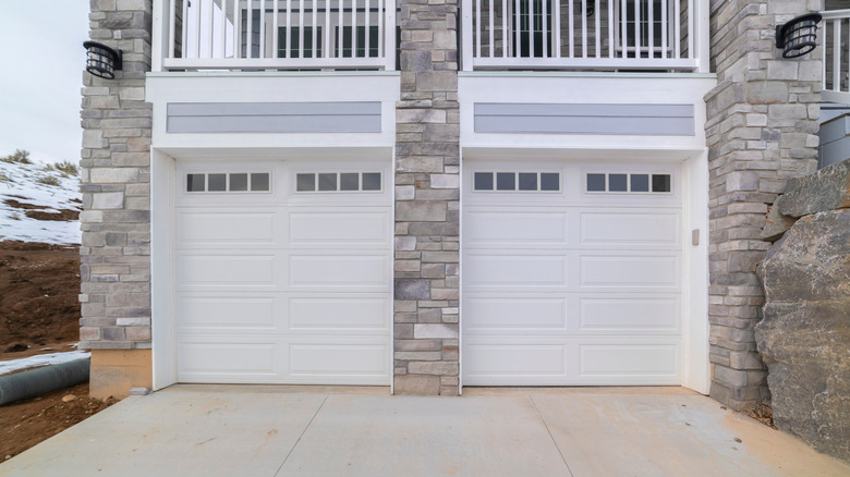 Two single garages share a concrete driveway