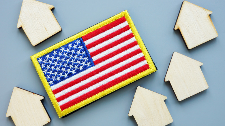 US flag with wooden houses