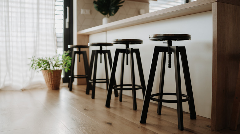 Black barstools under kitchen bar