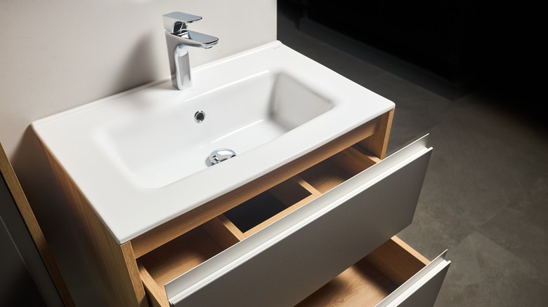 Open wood bathroom drawers under sink