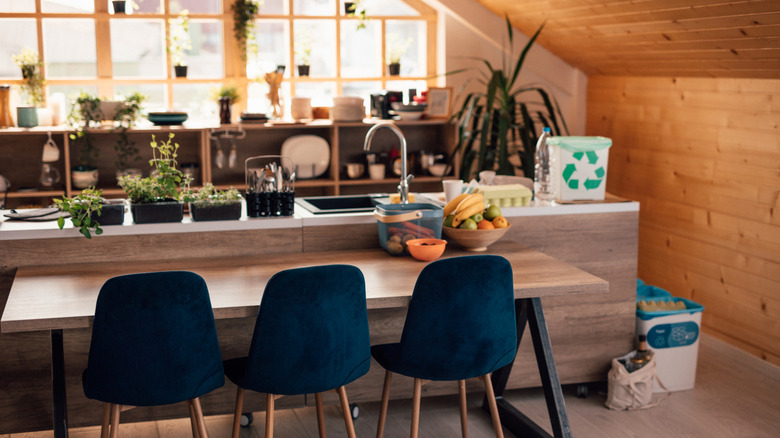Loft apartment kitchen with blue chairs