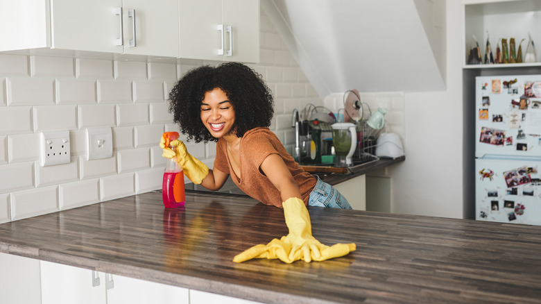 Woman cleaning kitchen counter