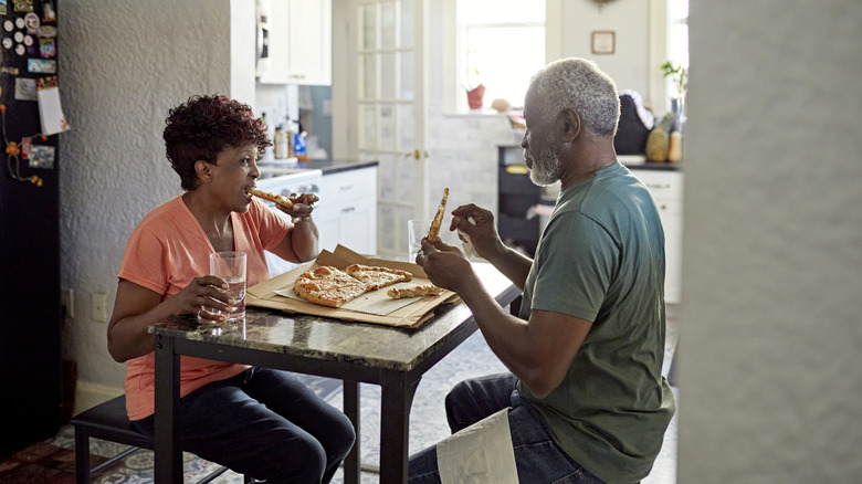 Retired couple having a meal in their kithcne