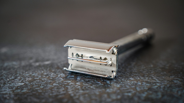 A closeup of a vintage metal safety razor