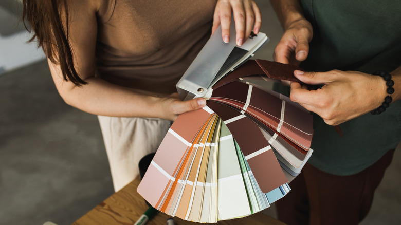Hands holding selection of paint chips