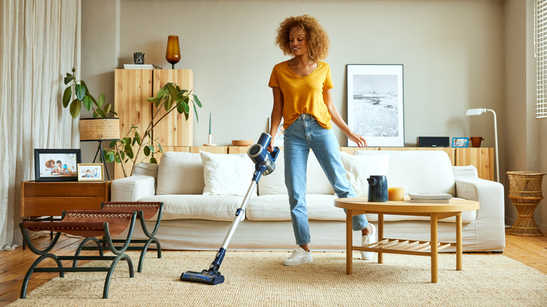 Woman vacuuming her living room
