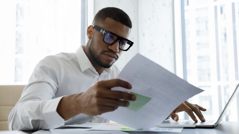 Man looking at paper