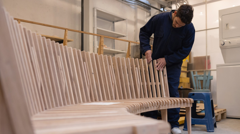 A man works on custom-made furniture