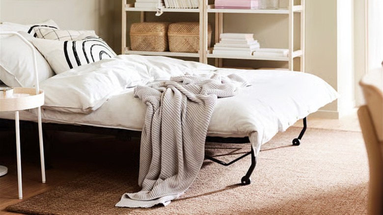 A LYCKSELE LÖVÅS sleeper sofa from IKEA is extended into a full-size bed