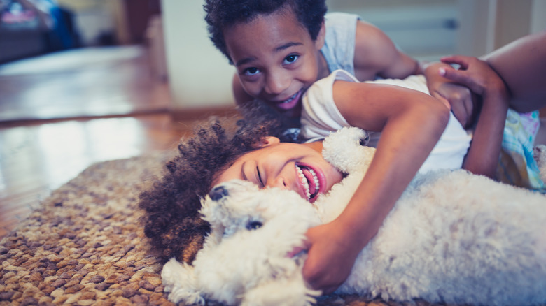 Children playing with dog