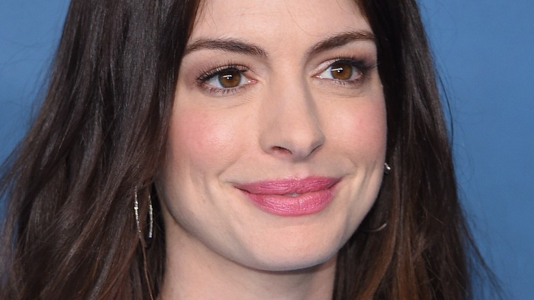 Anne Hathaway smiling at event
