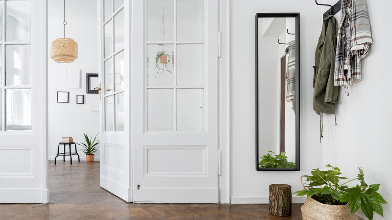 White-framed French doors separating two areas in an open concept space