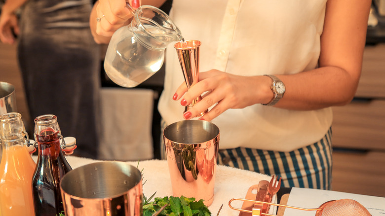 woman making a cocktail