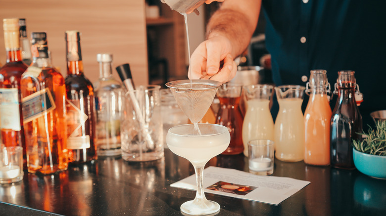man making a cocktail