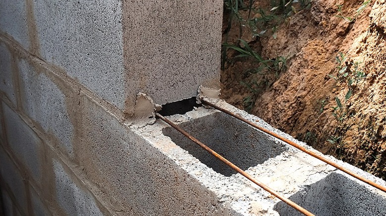 Stacked up concrete blocks glued together with rebar between the layers