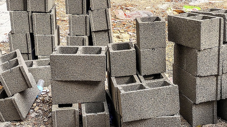 A stack of hollow concrete blocks stacked up outside