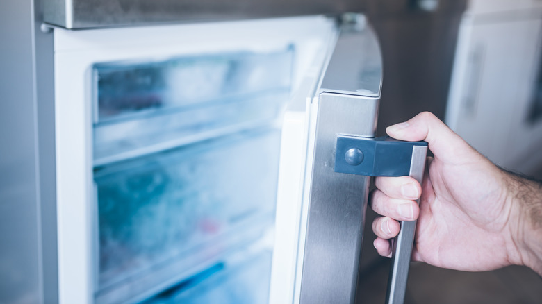 person opening freezer door