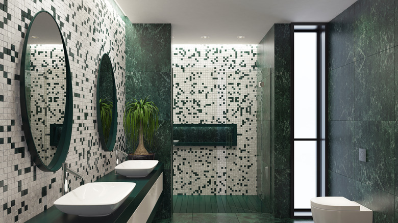 a luxurious bathroom with green tiles