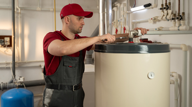 Repair man working on water heater