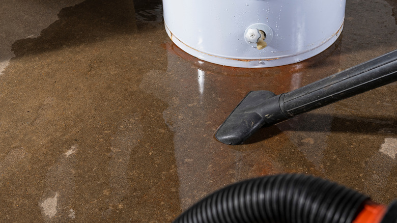 Wet vacuum cleaning up water from leaky water heater