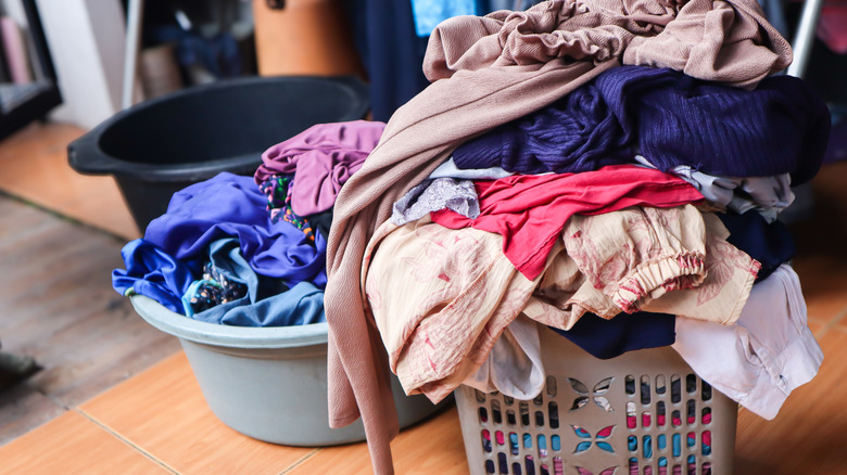 Laundry basket overflowing with dirty clothes at home