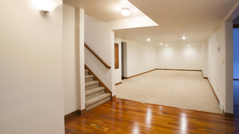 A finished basement with carpet and wood flooring
