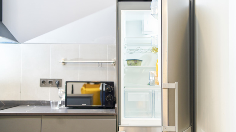 Door open of an almost empty fridge