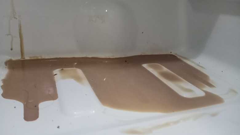 Chocolate liquid spilled inside the refrigerator