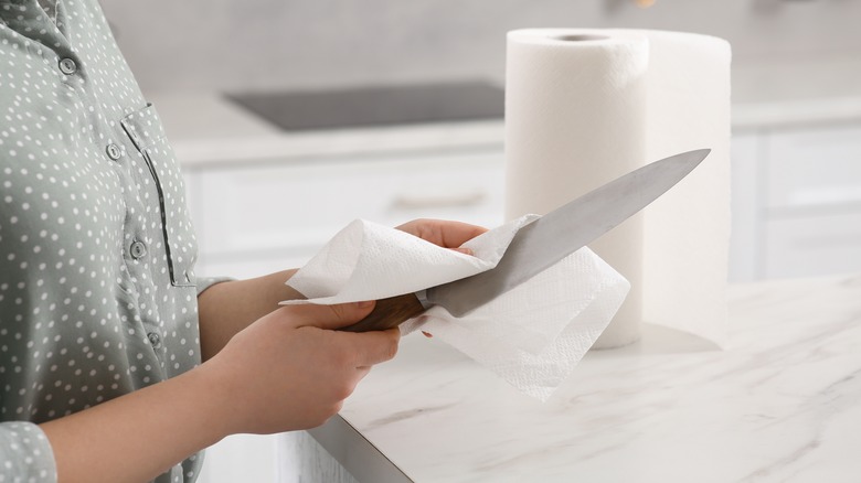 person drying a knife