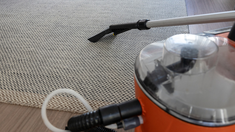 A vacuum cleaner on rug.