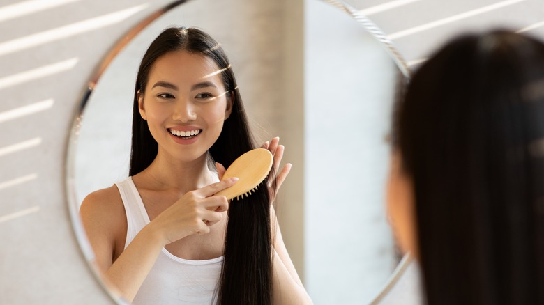 woman looking in mirror