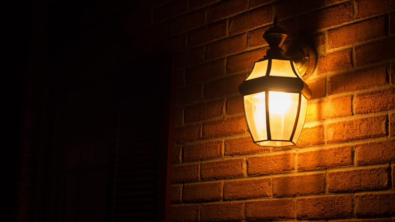 Lantern bulb on brick wall