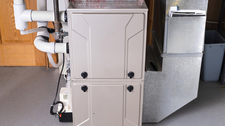 A residential double-stage gas furnace is installed in a basement