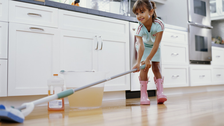 Little girl mopping floors