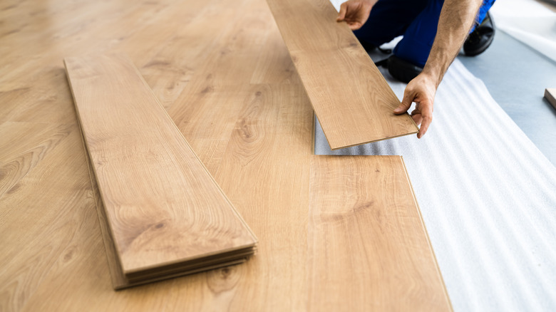 Person laying down hardwood floors