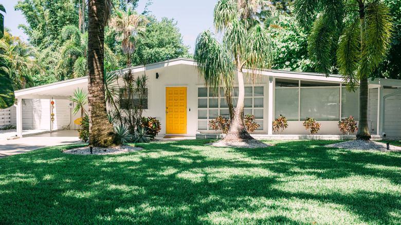 Atomic ranch style home with yellow door