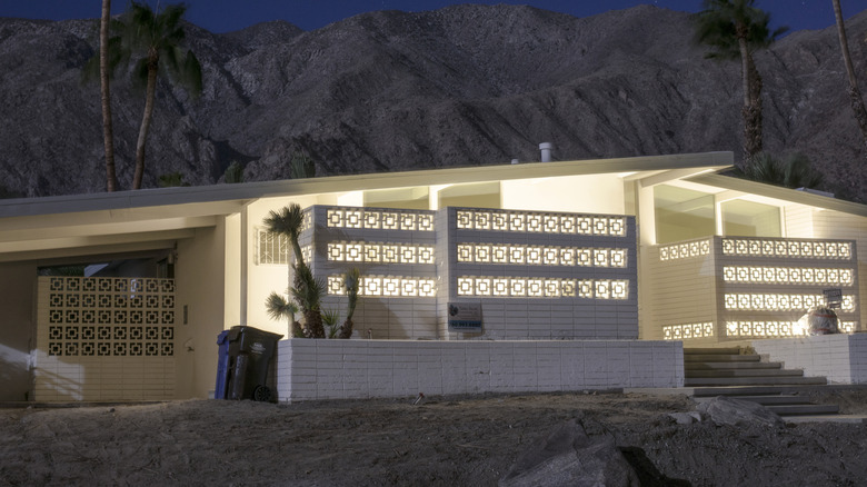 An atomic ranch home in California lit up at dusk