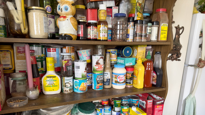 Disorganized kitchen shelves in need of customized pantry storage