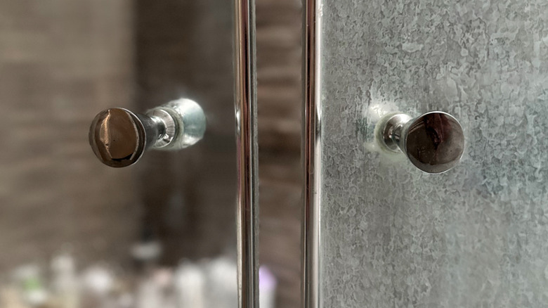 Soap scum on one side of glass shower door