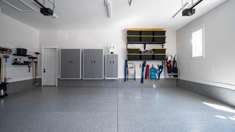 The inside of a garage with enclosed storage and shelving
