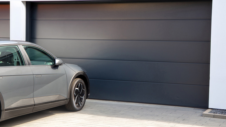Car outside, in front of closed garage door