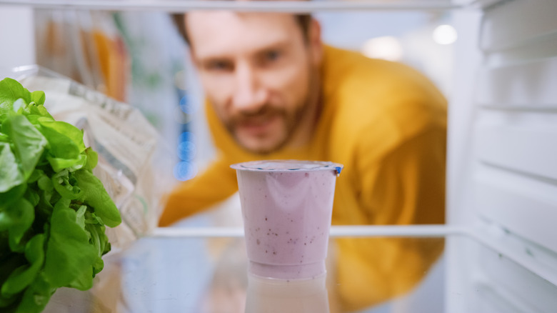 person opening fridge door