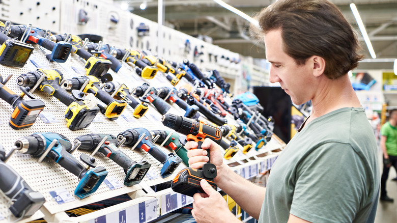 man shopping for cordless power drill