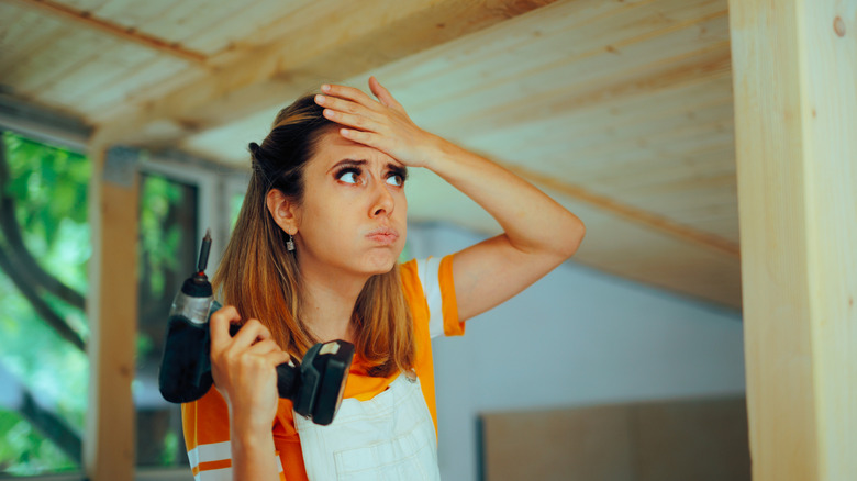 woman having difficulty with drilling work
