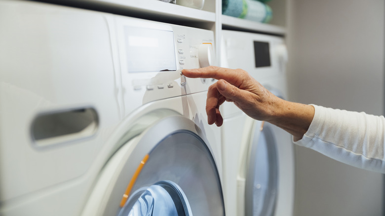 hand pressing dryer buttons